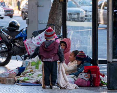 Homeless family living on street in bus stop shelter Homeless family living on street in bus stop shelter